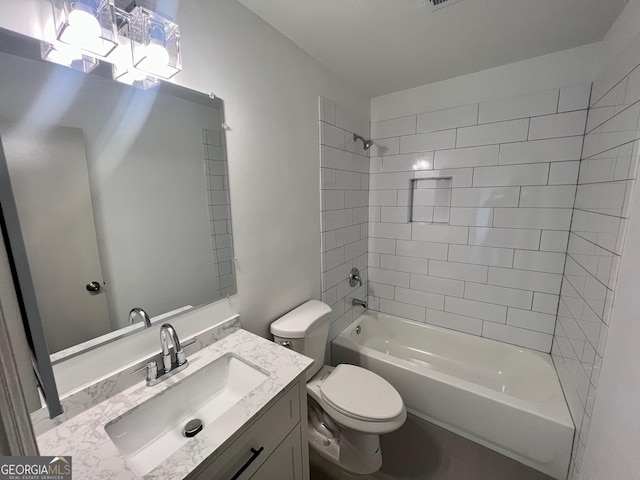 full bathroom featuring vanity, toilet, and tiled shower / bath