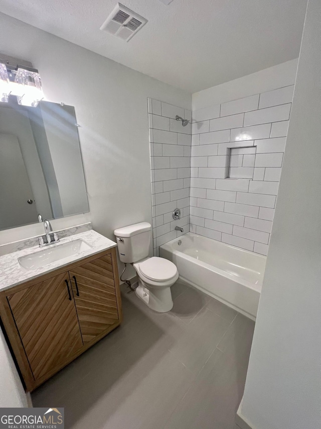 full bathroom with vanity, toilet, and tiled shower / bath combo