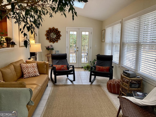 living room with lofted ceiling, light tile patterned floors, and french doors