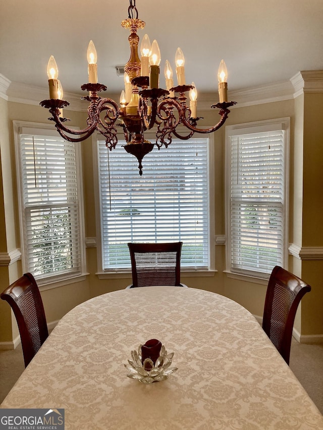 carpeted dining area featuring an inviting chandelier and ornamental molding