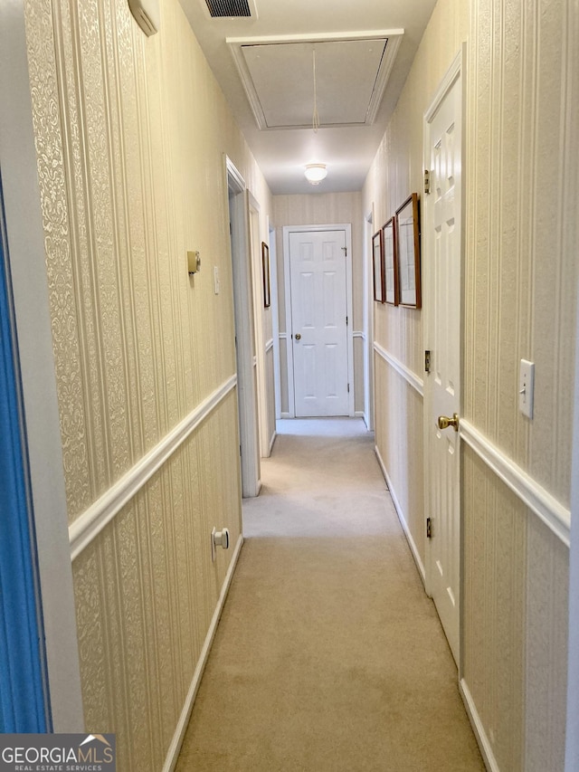 hallway featuring light carpet