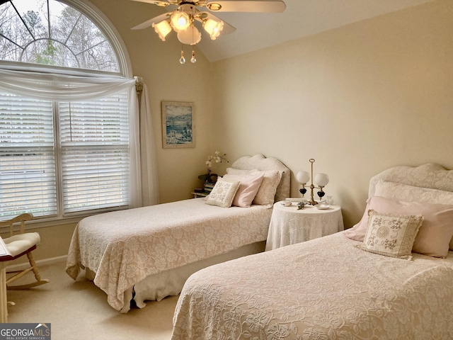 carpeted bedroom with ceiling fan, lofted ceiling, and multiple windows