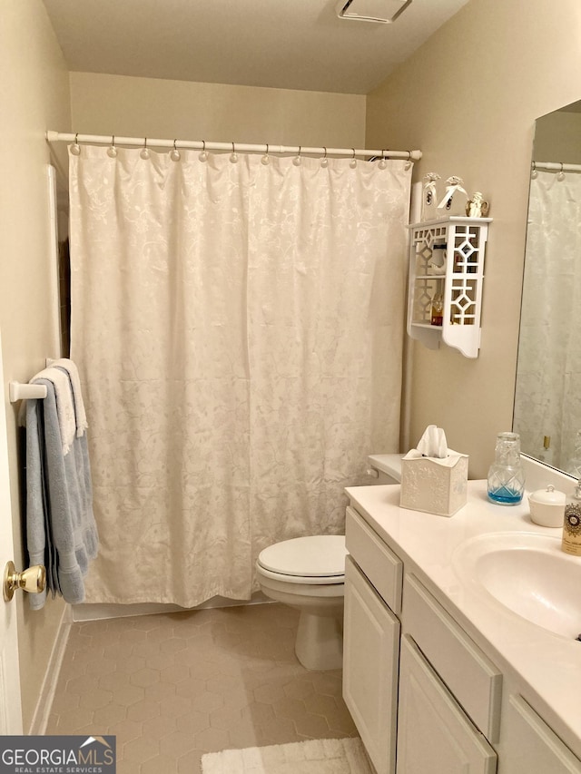 bathroom with vanity, tile patterned floors, and toilet