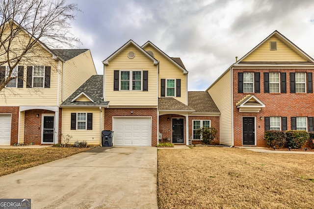 view of front of property featuring a garage and a front lawn