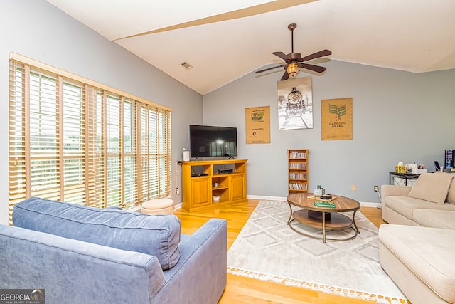 living room with vaulted ceiling, ceiling fan, and light wood-type flooring