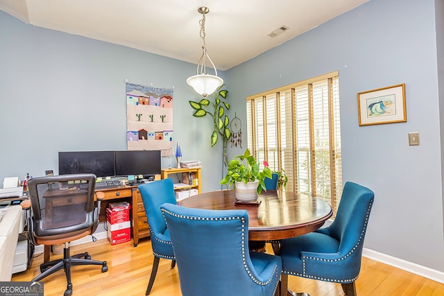 dining space with light hardwood / wood-style floors