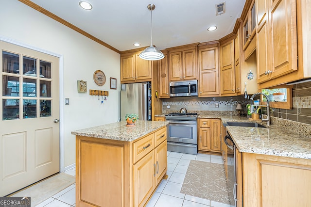 kitchen featuring pendant lighting, sink, appliances with stainless steel finishes, a center island, and light stone counters