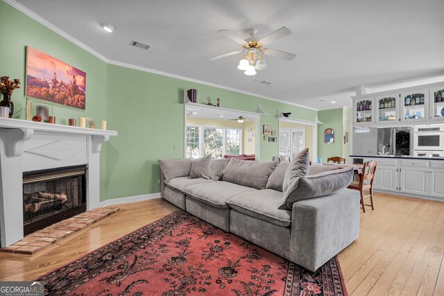 64 Lake No No Rd, Midway, GA 31320 - living room featuring ornamental molding, light hardwood / wood-style floors, and ceiling fan