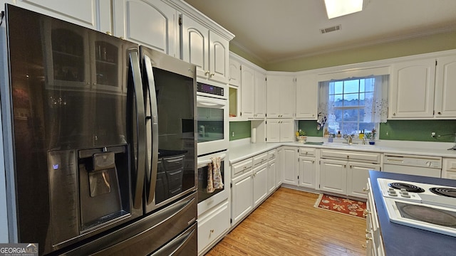 64 Lake No No Rd, Midway, GA 31320 - kitchen featuring stainless steel refrigerator, white cabinetry, ornamental molding, and white dishwasher