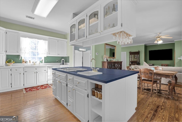 64 Lake No No Rd, Midway, GA 31320 - kitchen featuring white cabinetry, sink, and a center island with sink