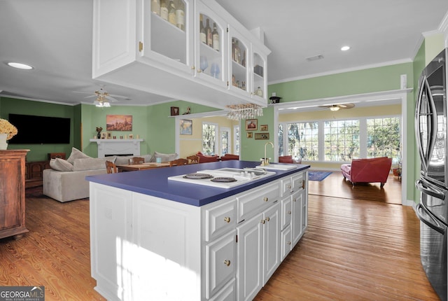 64 Lake No No Rd, Midway, GA 31320 - kitchen featuring crown molding, white electric stovetop, stainless steel fridge, ceiling fan, and white cabinets