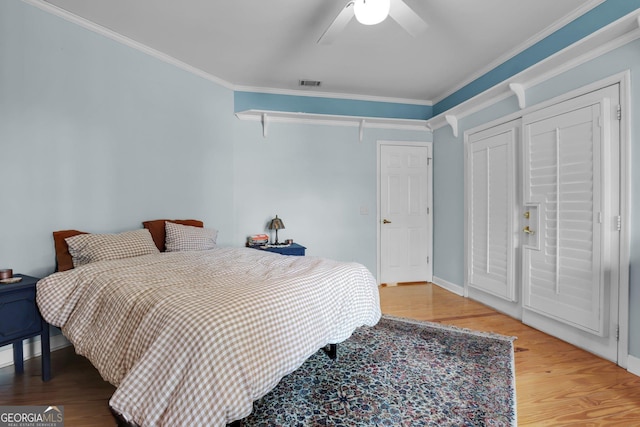64 Lake No No Rd, Midway, GA 31320 - bedroom with wood-type flooring, ornamental molding, and ceiling fan
