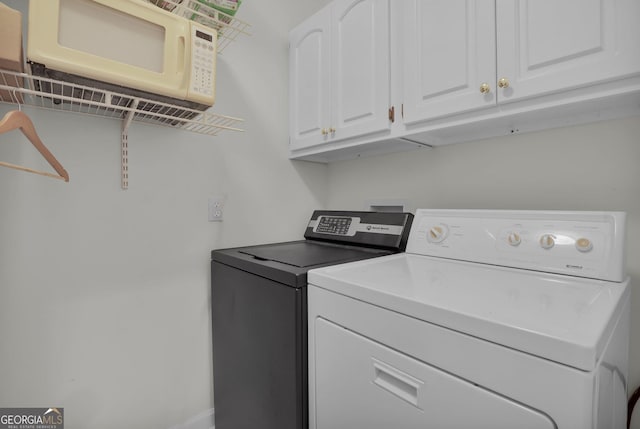 64 Lake No No Rd, Midway, GA 31320 - washroom featuring cabinets and separate washer and dryer