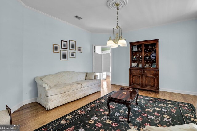 64 Lake No No Rd, Midway, GA 31320 - living room featuring an inviting chandelier, hardwood / wood-style flooring, and crown molding