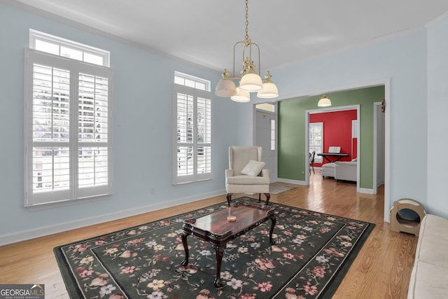 64 Lake No No Rd, Midway, GA 31320 - sitting room with an inviting chandelier, crown molding, a wealth of natural light, and wood-type flooring