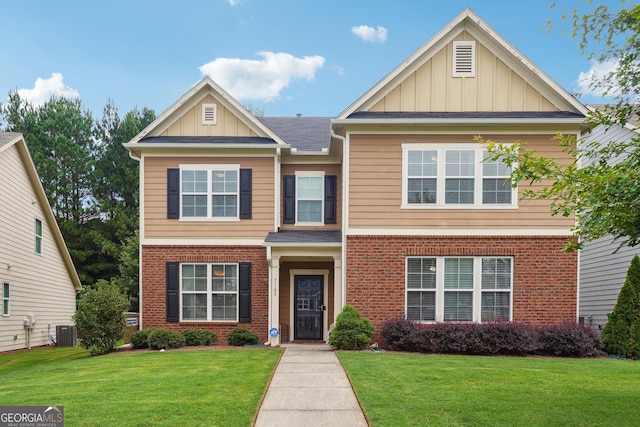 view of front of home with central AC and a front lawn