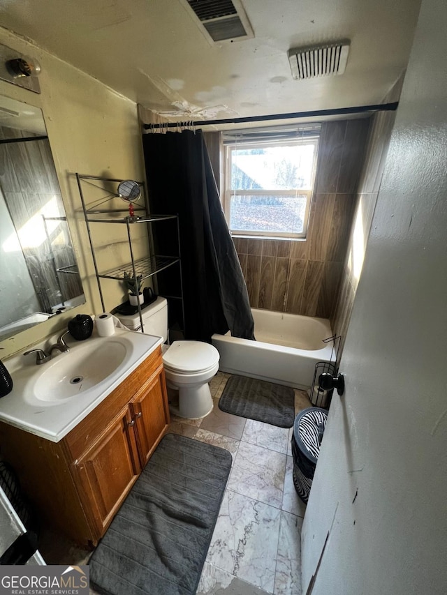 full bathroom featuring toilet, vanity, and shower / bathtub combination with curtain