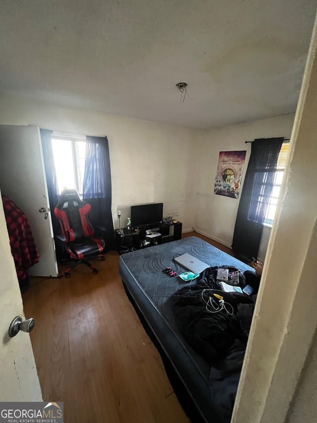 bedroom with hardwood / wood-style flooring