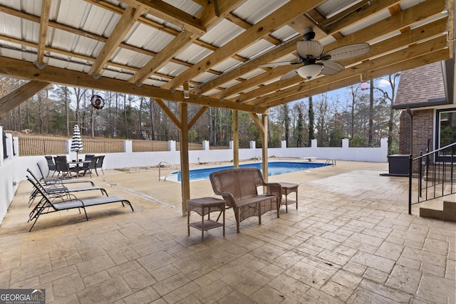 view of patio / terrace with a fenced in pool and ceiling fan