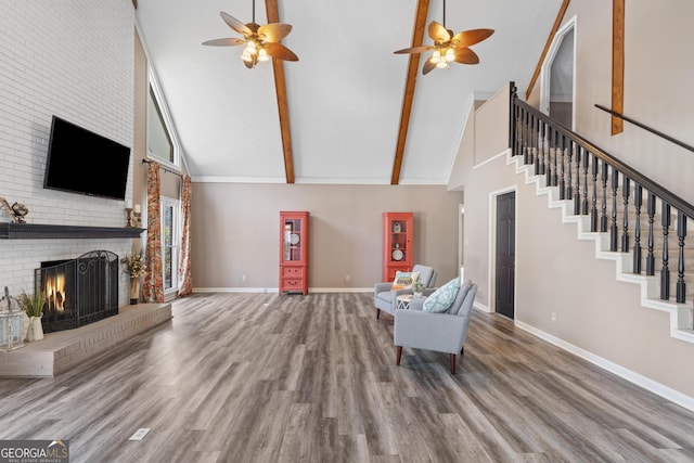 unfurnished living room with a brick fireplace, high vaulted ceiling, hardwood / wood-style floors, and beamed ceiling