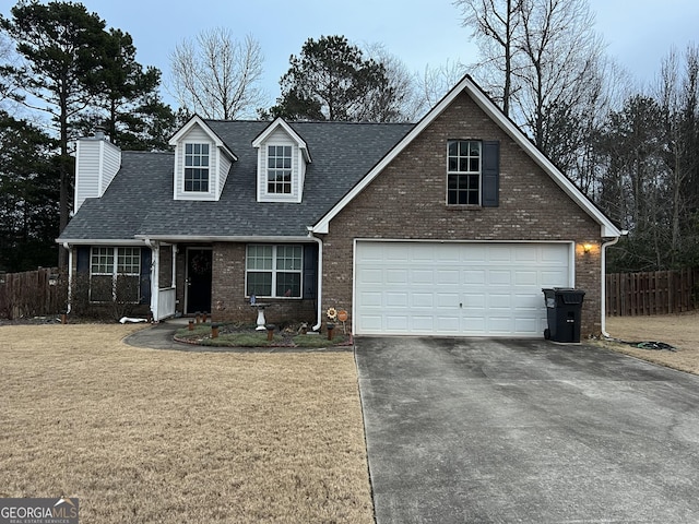 view of front of home featuring a garage and a front yard