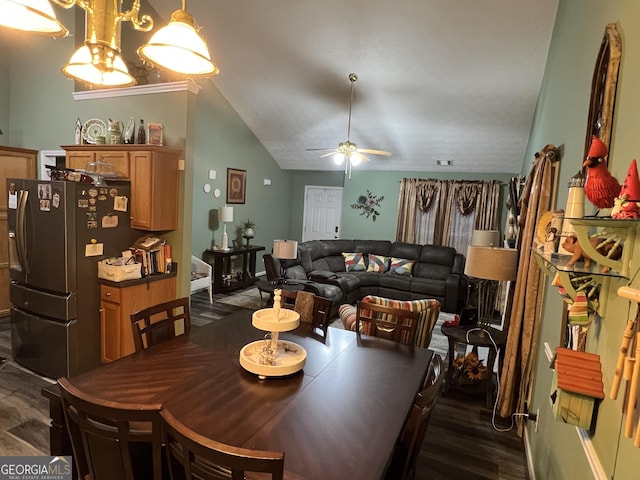 dining area featuring ceiling fan, dark hardwood / wood-style flooring, and vaulted ceiling