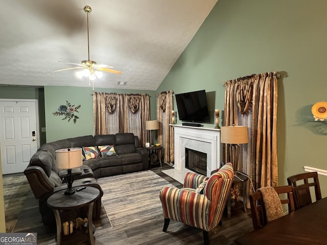 living room with a premium fireplace, lofted ceiling, hardwood / wood-style floors, and ceiling fan