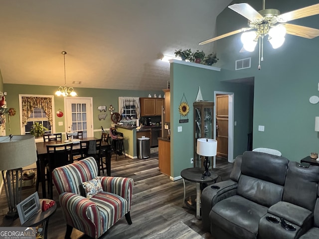 living room with lofted ceiling, dark hardwood / wood-style floors, and ceiling fan with notable chandelier