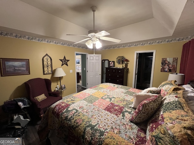 bedroom featuring ceiling fan and a raised ceiling