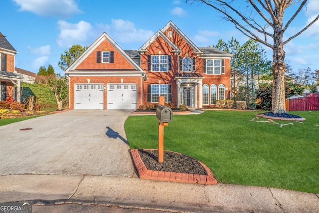 view of front of property with concrete driveway, brick siding, a front yard, and fence