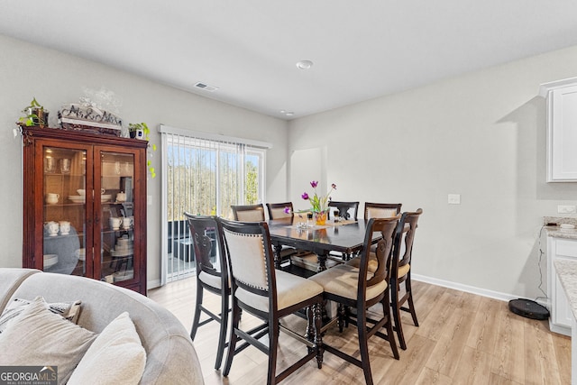 dining area featuring light wood-type flooring