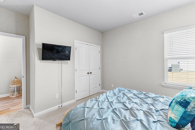 carpeted bedroom featuring a closet