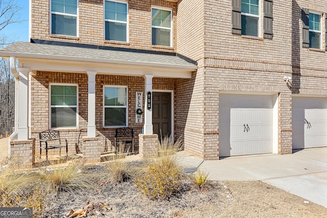 view of front of house featuring a garage and a porch