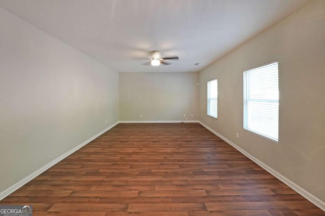 spare room with ceiling fan and dark hardwood / wood-style flooring