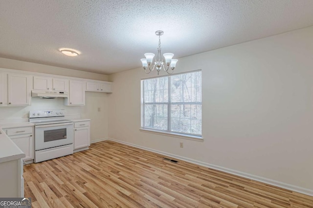 kitchen with white cabinets, electric range, light hardwood / wood-style floors, and decorative light fixtures