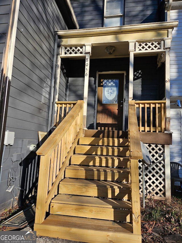 view of exterior entry with covered porch