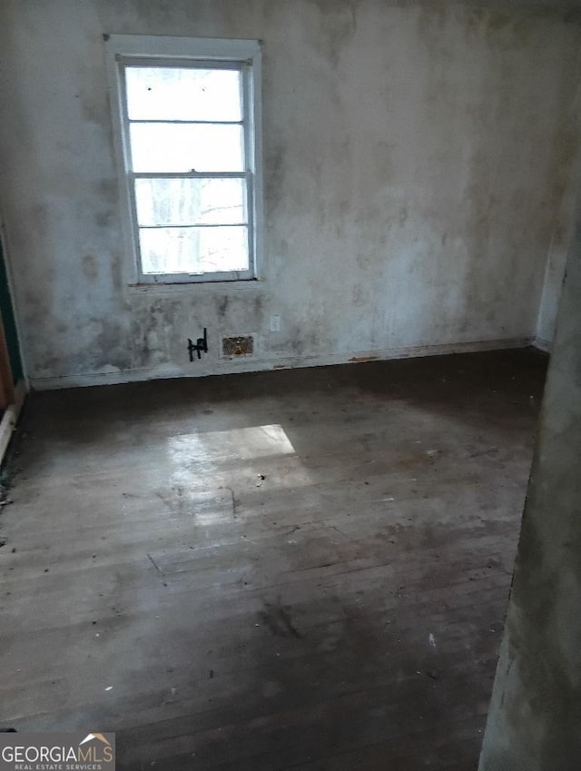 unfurnished room featuring dark hardwood / wood-style flooring