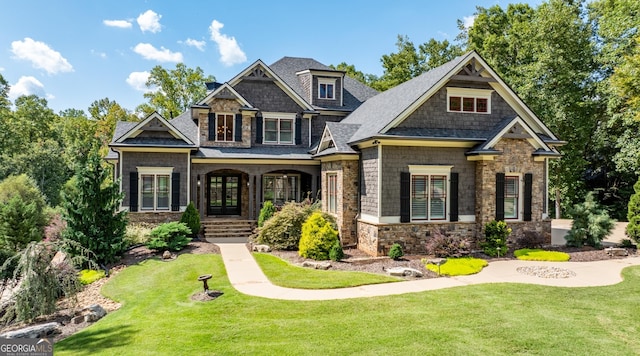 craftsman inspired home with a front lawn