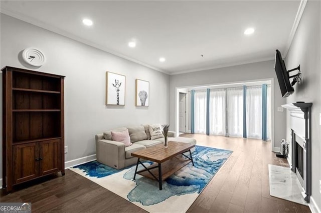 living room with wood-type flooring and crown molding