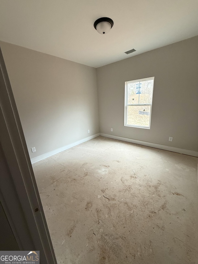 unfurnished room with visible vents and baseboards