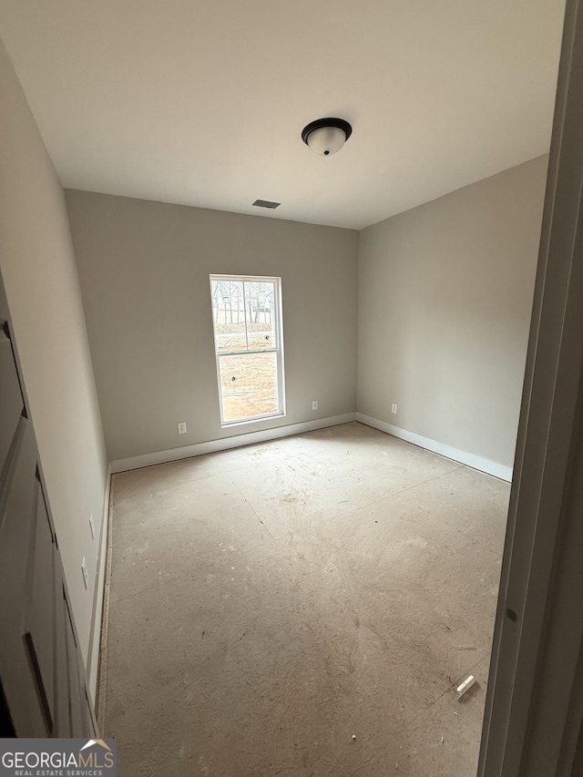 empty room featuring visible vents and baseboards