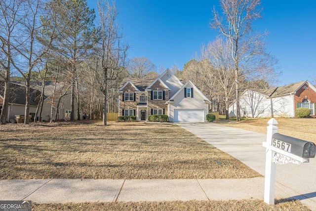 view of front of home with a garage and a front yard