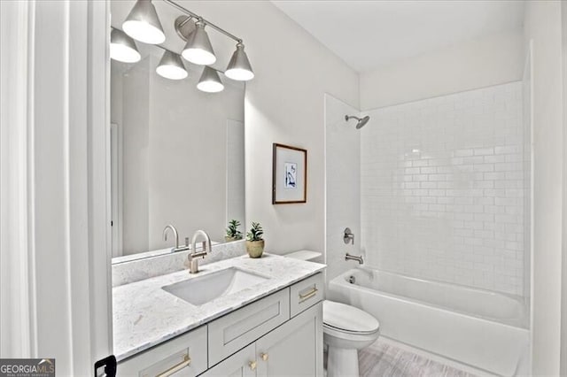 full bathroom featuring vanity, toilet, and tiled shower / bath combo