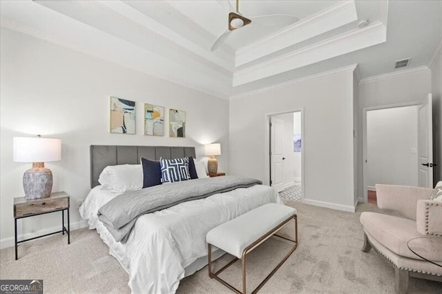 carpeted bedroom with a raised ceiling and crown molding