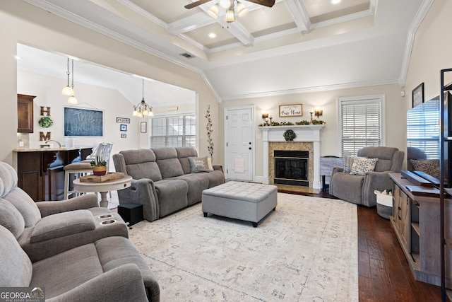 living room with ceiling fan with notable chandelier, lofted ceiling with beams, wood-type flooring, ornamental molding, and coffered ceiling