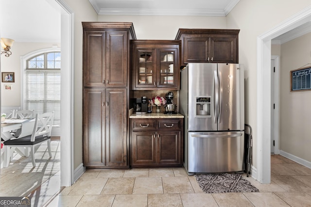 kitchen featuring crown molding, dark brown cabinets, and stainless steel fridge