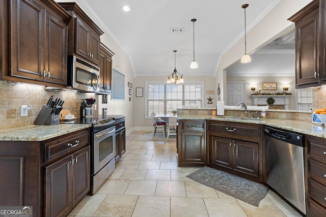 kitchen with appliances with stainless steel finishes, decorative light fixtures, dark brown cabinets, and backsplash