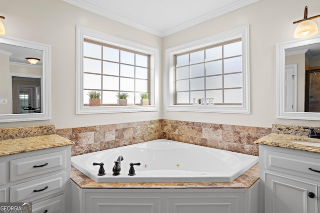 bathroom featuring crown molding, vanity, and a bathtub