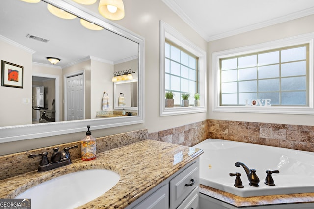 bathroom featuring ornamental molding, a bath, and vanity