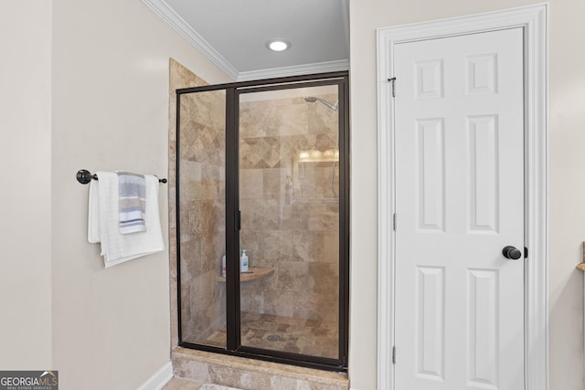 bathroom with ornamental molding and a shower with door